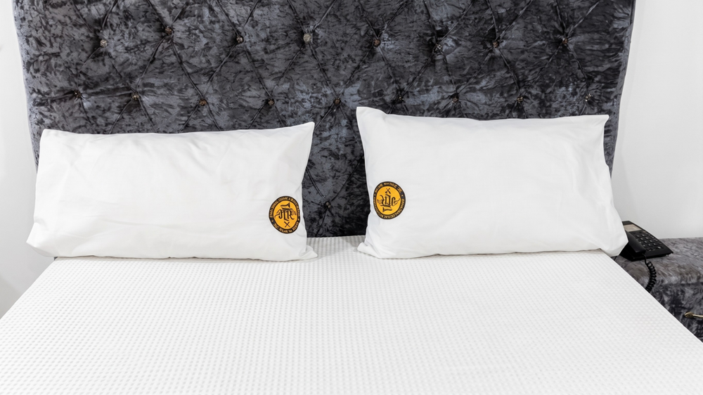 Signature pillows on tufted headboard